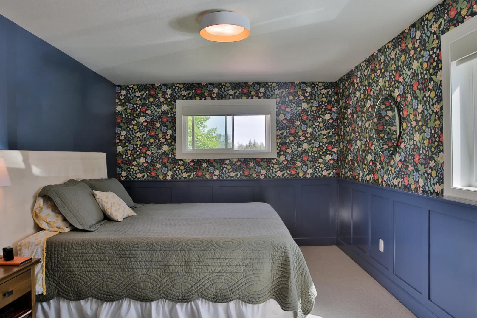 ADU bedroom with board-and-batten wainscot and floral wallpaper above